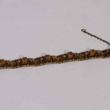 Turun Hopea Kelo rannekoru, pronssi, suunnittelija Pentti Sarpaneva, pronssi, kivellinen, tiikerinsilmä